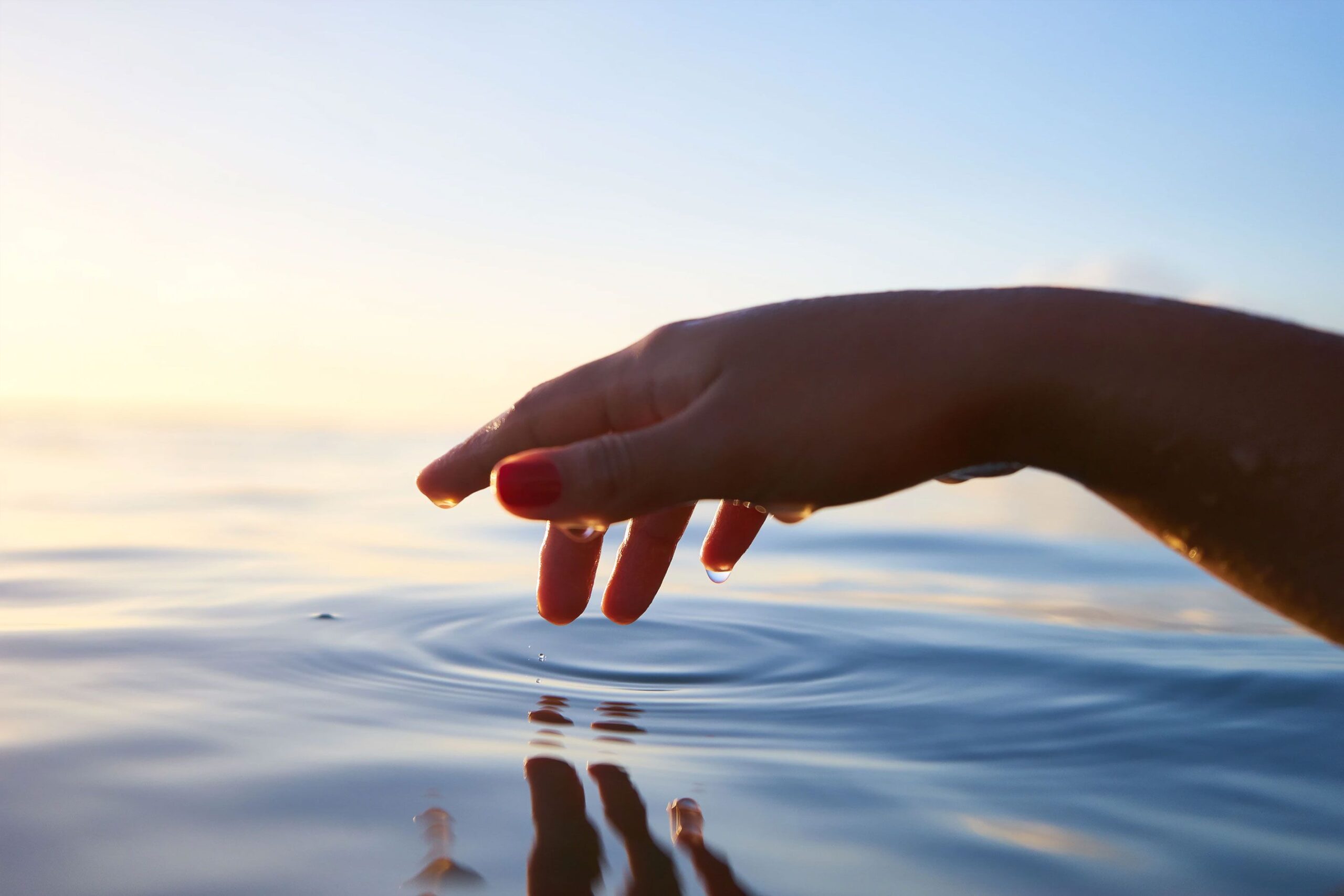 Hand Hovering Above Water